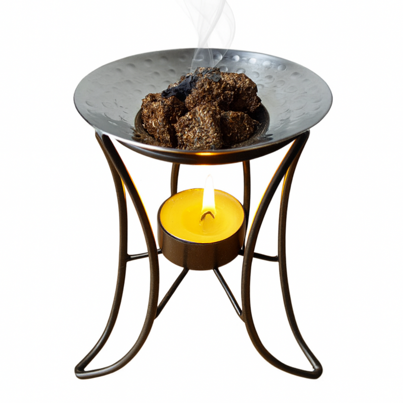 Bakhoor burner iron with a candle on a white background