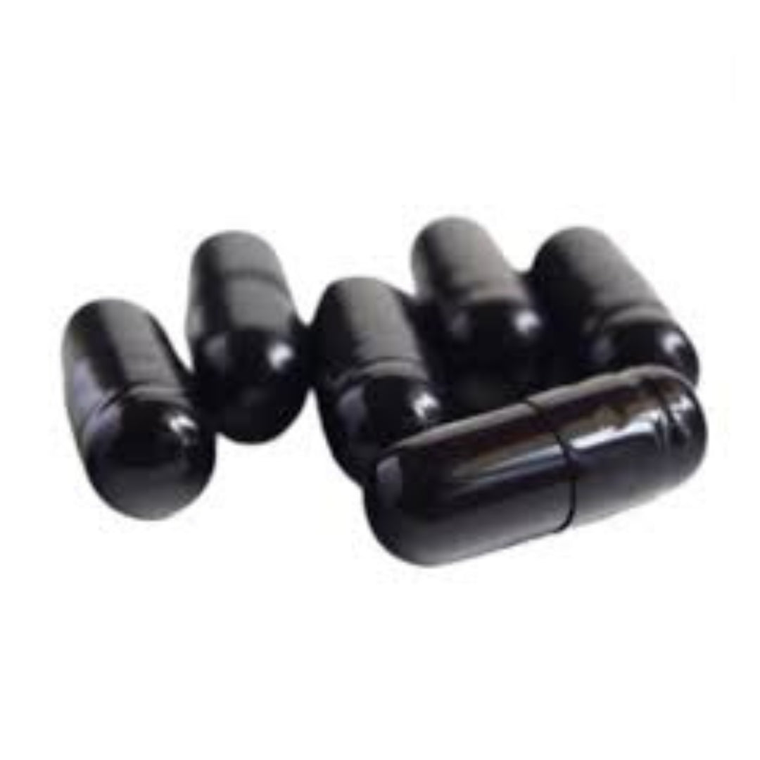 Row of black capsules containing Shilajit supplement displayed against a white background.
