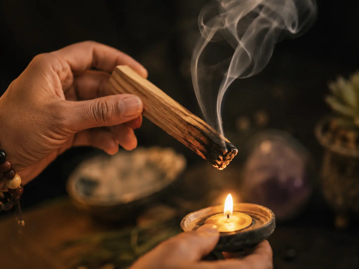 Smudging a home with white sage and candlelight