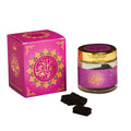 Jars of Oudh Bakhour with decorative pink packaging on a white background