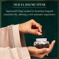 Oud Ya Aini incense packaging with jar of incense sticks on a white background