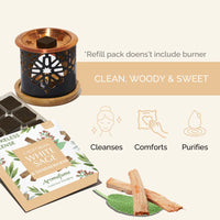 Aromatherapy diffuser with essential oil packaging and wooden sticks on a white background