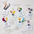 Collection of Arogya Ayu diffuser bags with various scents and corresponding flowers on a light background