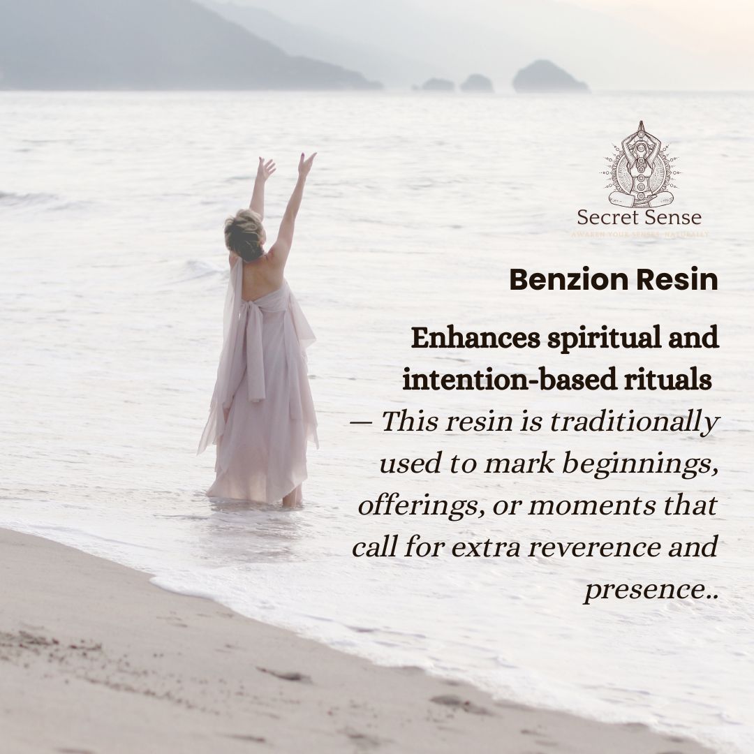 Woman in a long dress standing on a beach with mountains in the background, promoting Benzion Resin.