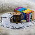 7 Chakra Incense burner with packets and a colorful box on a white fur background