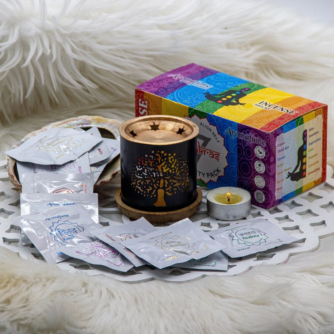 7 Chakra Incense burner with packets and a colorful box on a white fur background