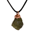 Close-up View of Authentic Moldavite Pendant with Copper Setting