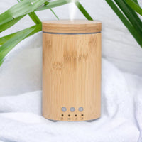 Escentia Bamboo Diffuser emitting a gentle mist, enhancing indoor and outdoor spaces
