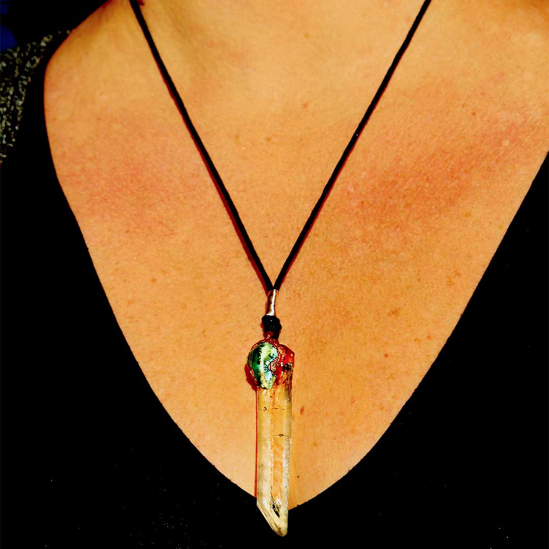 Orbicular Jasper and Quartz Crystal Pendant against a Serene Background