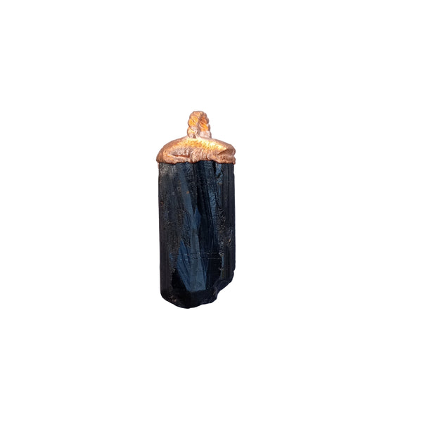 Black Tourmaline crystal pendant with copper cap resting on an open palm — grounding energy jewellery by Secret Sense