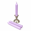 Purple ritual candles with a silver candle holder on a white background