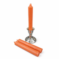 Orange ritual candles with a silver candle holder on a white background
