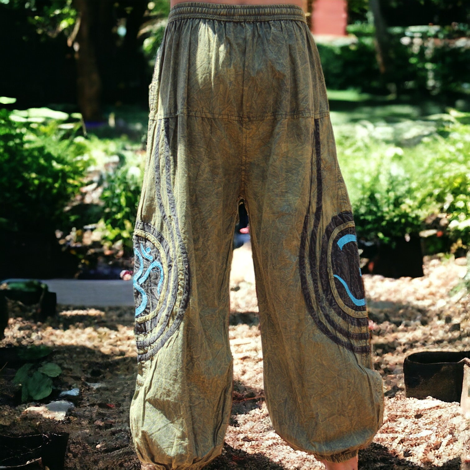 Model showcasing Secret Sense's Earthy Embroidered Harem Pants in a serene garden setting
