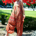 Woman enjoying a vibrant orange Mantra Jumpsuit with Thin Straps by Secret Sense