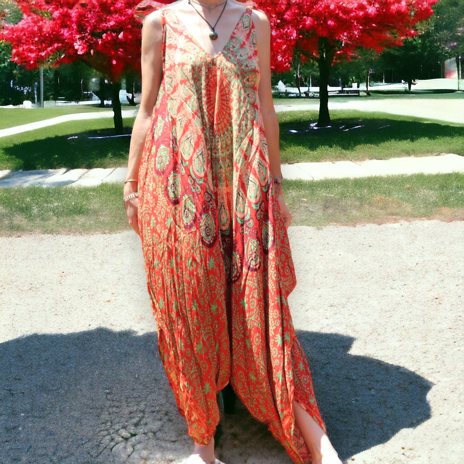 Woman enjoying a vibrant orange Mantra Jumpsuit with Thin Straps by Secret Sense
