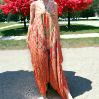 Woman enjoying a vibrant orange Mantra Jumpsuit with Thin Straps by Secret Sense