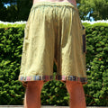 Man wearing Secret Sense Tribal Breeze Boho Shorts with earthy patterns