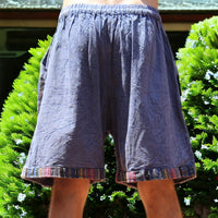 Man in Secret Sense Nomadic Spirit Boho Shorts amidst vibrant greenery