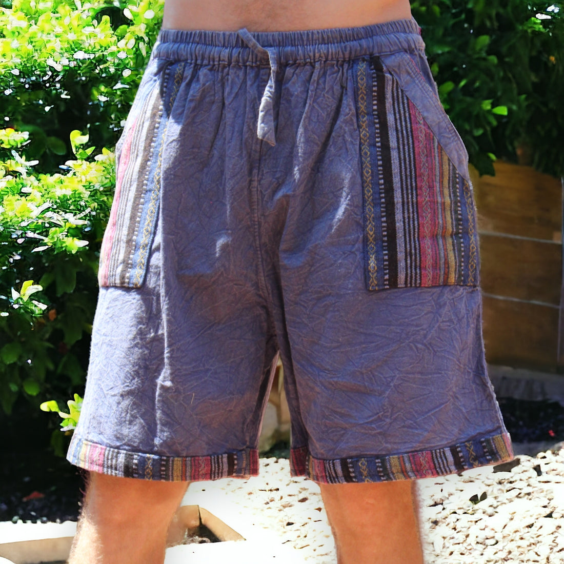 Man in Secret Sense Nomadic Spirit Boho Shorts amidst vibrant greenery