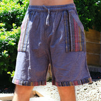 Man in Secret Sense Nomadic Spirit Boho Shorts amidst vibrant greenery