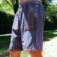 Man in Secret Sense Nomadic Spirit Boho Shorts amidst vibrant greenery