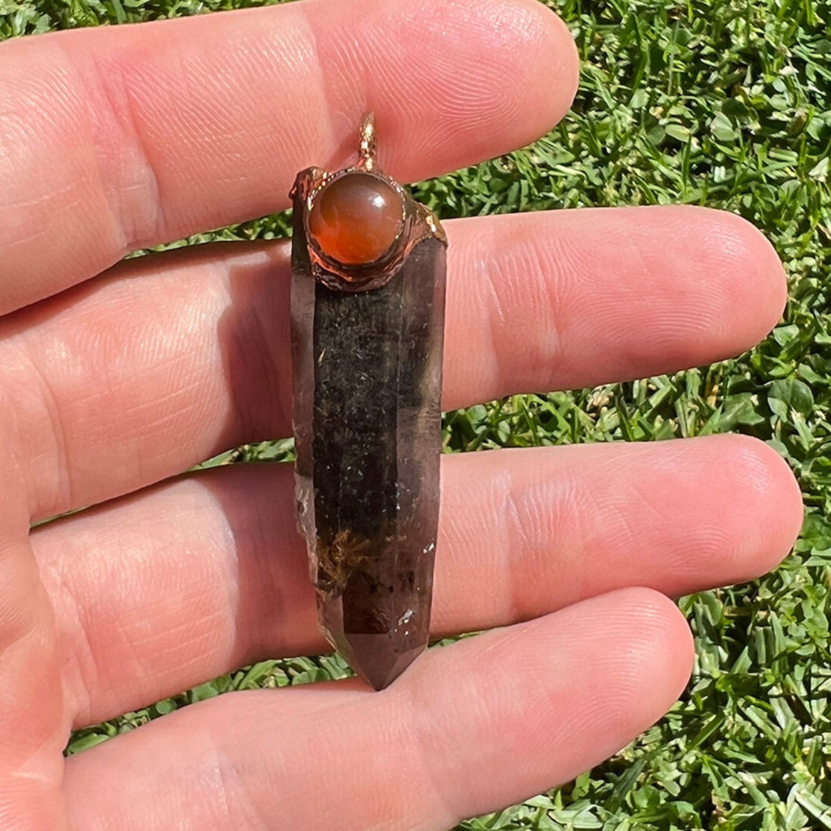 Smoky Quartz Carnelian Pendant Shown in Hand – Natural Crystal Energy Tool