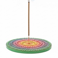 Colorful Mandala incense holder with a single incense stick on a white background