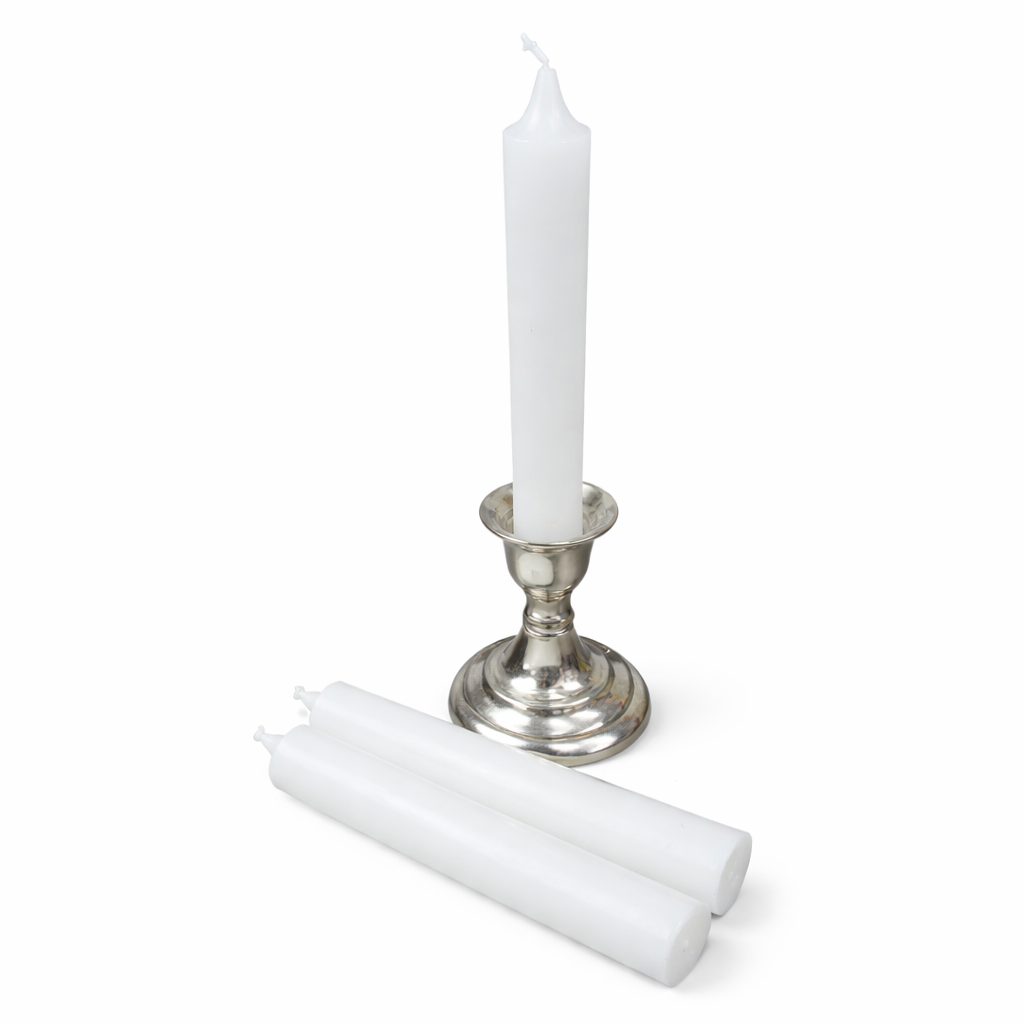 White ritual candle and two white candles on a silver candlestick against a white background