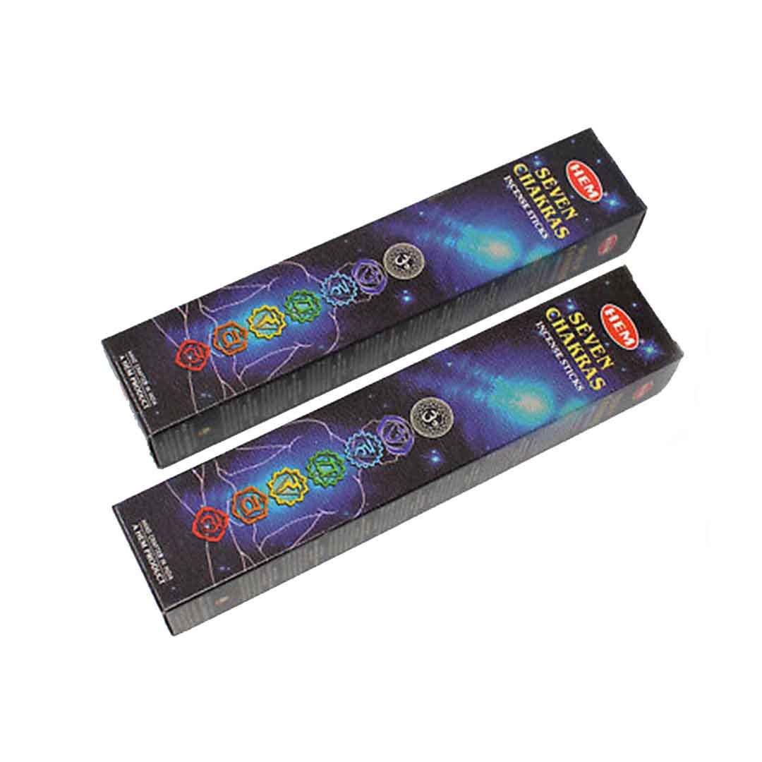 HEM 7 Chakras Incense Stick lit in a serene meditation space, casting a soft glow and releasing calming scents for chakra balancing.
